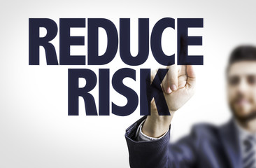 Business man pointing the text: Reduce Risk
