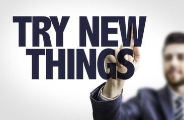 Business man pointing the text: Try New Things
