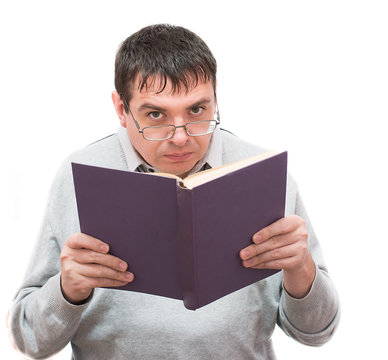 man with glasses reading a book