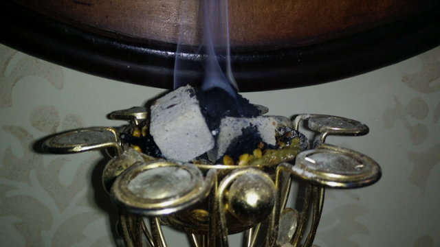 Smoke rising from the incense burner