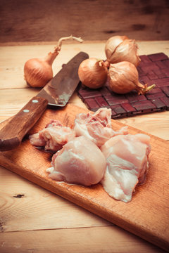 raw fillet chicken meat and onions.the toned image