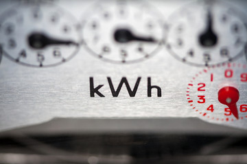 Electric meter and dials close-up, concept for higher bills, fuel, rising costs and energy billing.