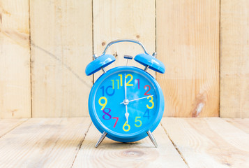 Alarm Clock , in blue, showing six o'clock
