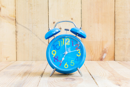 Alarm Clock , in blue, showing seven o'clock