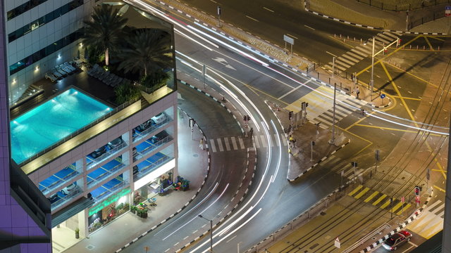 Traffic on intersection with tram at night timelapse from top