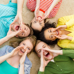 smiling people lying down on floor and screaming