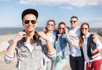 teenage boy with sunglasses and friends outside