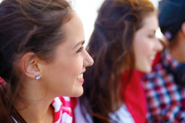 Fototapeta premium smiling teenage girl outdoors with friends