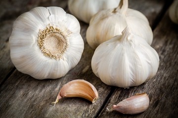 Organic garlics with cloves close up on a wooden table