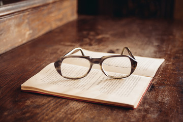 vintage glasses on old book