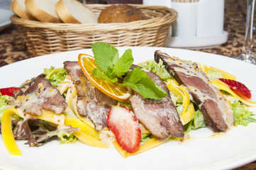 salad of duck meat and vegetables in a restaurant