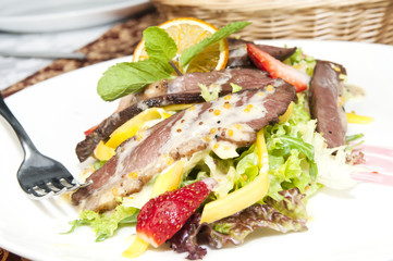 salad of duck meat and vegetables in a restaurant