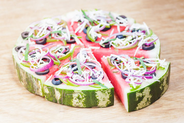 Watermelon pizza on wood