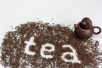 Black tea and teapot on white background