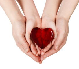 Obraz premium Mother's hands holding baby hands with heart