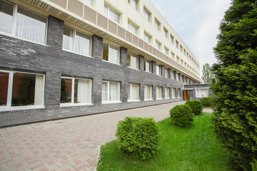 green grass, office building