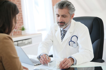 Doctor giving prescription to patient