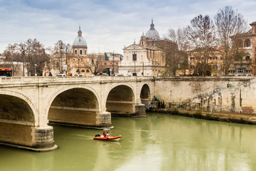 Fototapeta na wymiar Bridge over the Tiber river in the center of Rome