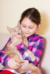 child tenderly embraces kitten