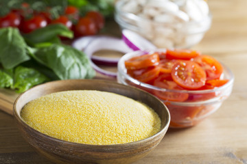 Raw Polenta and Sliced Tomatoes