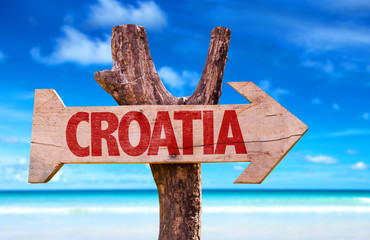 Croatia wooden sign with a beach on background