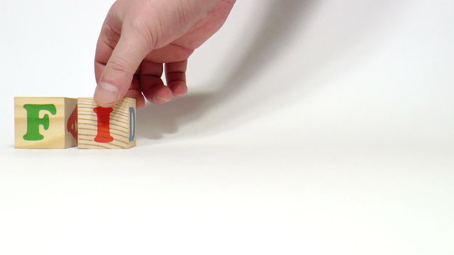The video shows finance word built of wooden blocks
