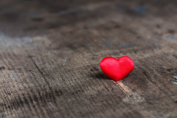 Fototapeta premium Red heart on a wooden table