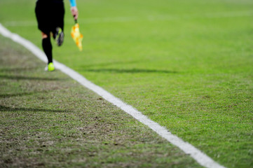 Assistant referee in action on a soccer field