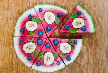 Watermelon pizza on wood