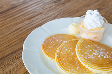 Pan cake with ice cream on wood table
