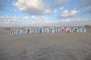 Happy Birthday on multicolored stones