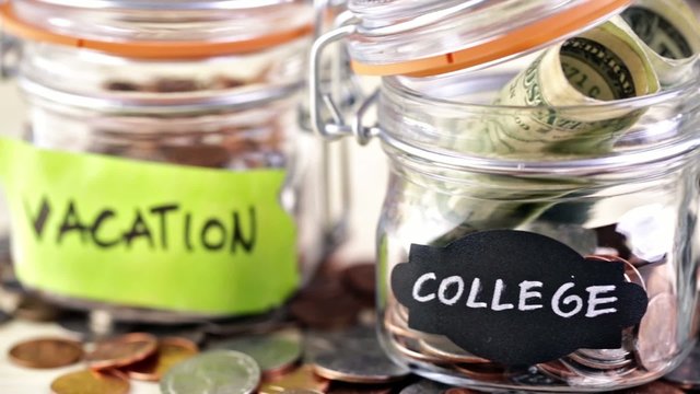 Saving money into glass jar for future investment.