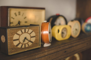 Old clocks on a shelf with oldschool vintage