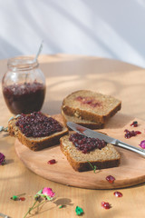 Fresh baked homemade healthy bread blackcurrant jam breakfast