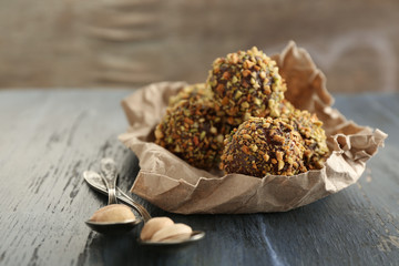 Tasty homemade pistachio candies on wooden table