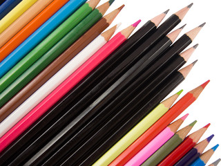 Fototapeta premium Multiple crayons and black pens diagonal