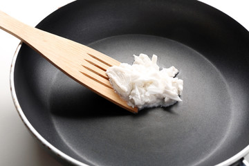Coconut oil in frying pan close up