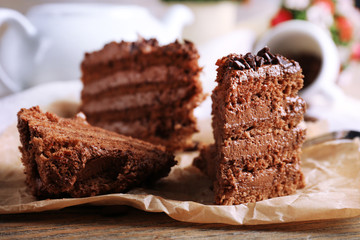 Slices of tasty chocolate cake on plate on table close up