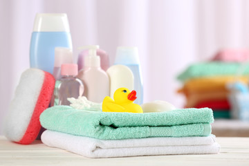 Baby accessories for bathing on table on light background