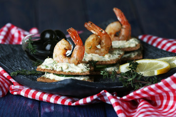 Appetizer canape with shrimp and olives