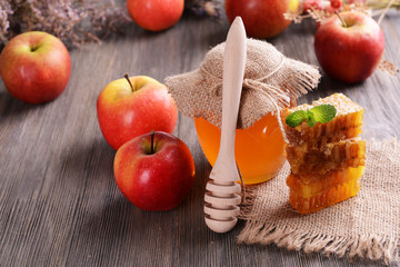 Delicious honey with apple on table close-up