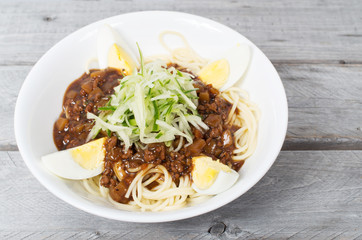 Korean Black Bean Sauce Noodles, Jajangmyeon, on a wooden table