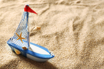 Toy model of ship on sea sand background