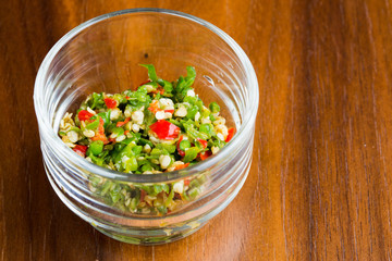 Sliced chilli in a small bowl on wooden table