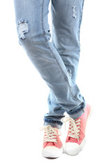 Human legs in jeans and shoes isolated on white