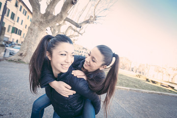 Female Twins Playing together and Enjoy Getting Piggyback Ride