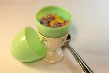 Plastic egg with candy covered chocolates