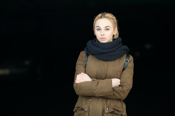 Outdoors portrait of young serious hipster woman