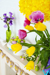 Fireplace with beautiful spring decorations in room