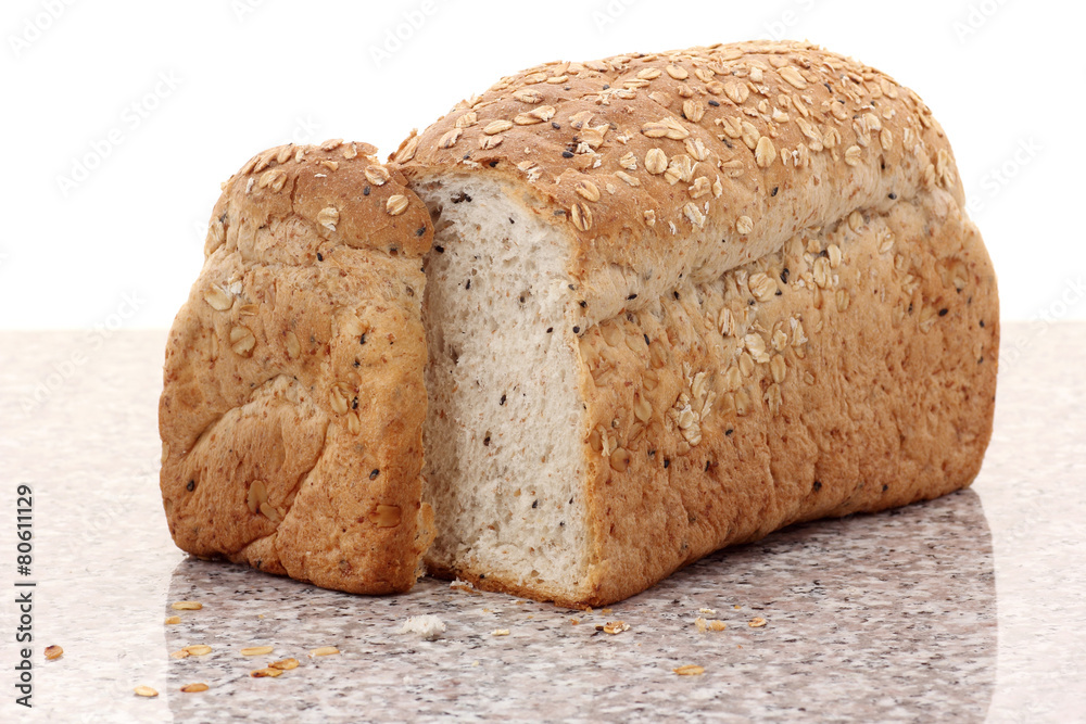 Wall mural whole wheat bread sliced on marble table